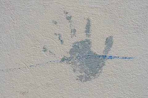 A hand print is on a wall. Stock Photos