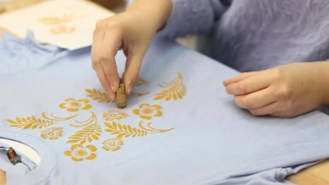 Hand-printed pattern on fabric. Print a picture on a blue T-shirt. Modern Stock Footage 170478234