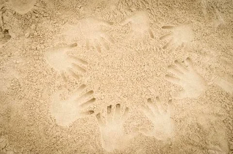 Hand prints in the sand Stock Photos