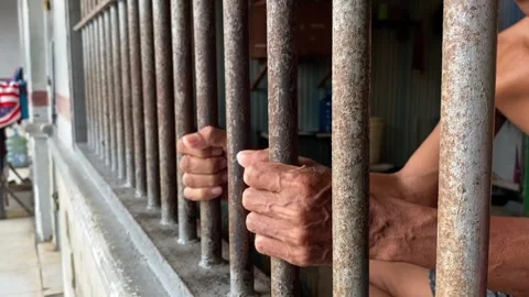 A hand of prisoner in cell of prison Stock Footage 277683780