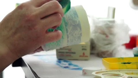 Hand of professional designers make pattern on a ceramic mug. Stock Footage 72371585