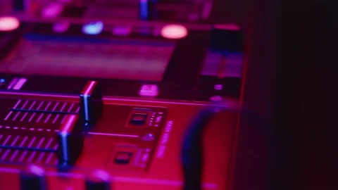 Hand of professional DJ adjusts cue slider on fader in digital music console in Stock Footage 159656510
