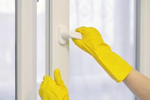 Hand in protective glove opens and closes window. Stock Photos