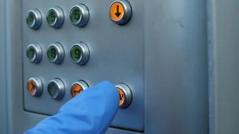 Hand in a protective glove presses code buttons on the intercom Video stock 128879653