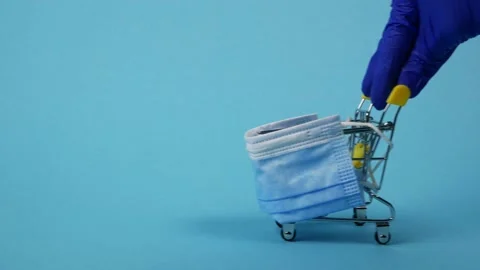 Hand in a protective glove pushes empty shopping cart. Concept of safe shopping Video stock 142324797