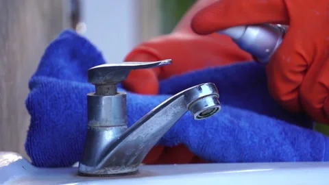 Hand in protective glove using wet wipe to disinfect the water tap Stock-Footage 147868798