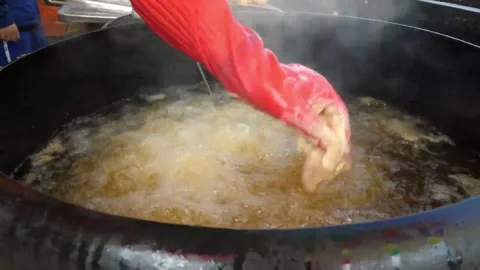 Hand in Protective Red Glove Stirring Large Pot of Boiling Liquid Video stock 343587824