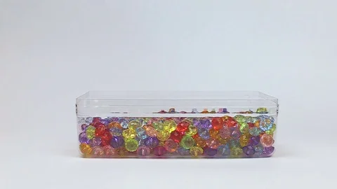Hand puffs beads. beads in a box, Stock Footage 80868989