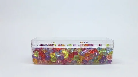 Hand puffs beads. beads in a box, Stock Footage 80869044