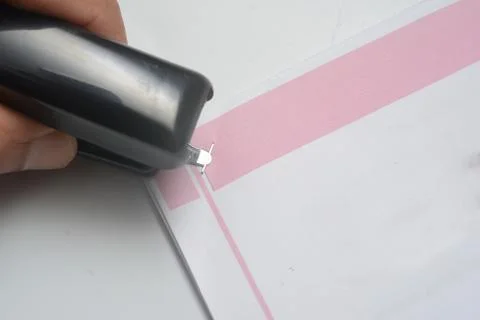 A hand is pull off the clip on a bunch of paper. Stock Photos