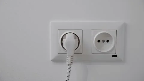 Hand pull out charger adapter into wall socket. Energy Saving Concepts and Techn Video stock 131880551