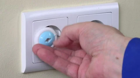 Hand pull out plug wire from outlet and insert child safety plug Stock Footage 64779063