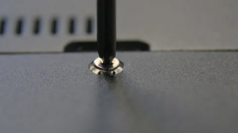A hand-pulled craftsman tightens a screw with a screwdriver. Stock Footage 170796792