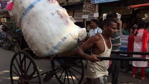 Hand pulled Rickshaw carrying passenger and goods in the street of Kolkata Stock Footage 98914745