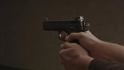Hand pulling back hammer of 9mm pistol and firing a bullet Video stock 229754867