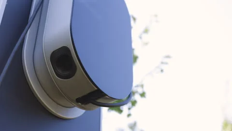 Hand pulling in cable from EV car charger or electric vehicle station. Cable 스톡 동영상 249923442