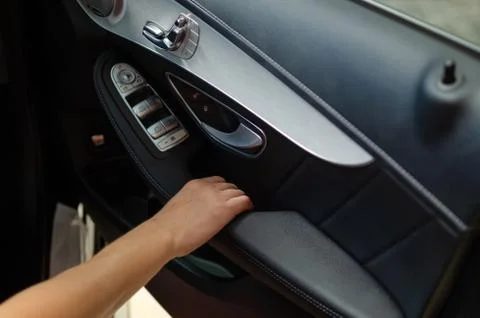 Hand pulling car interior door handle Stock Photos