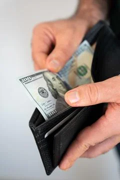 Hand pulling cash from wallet Stock Photos