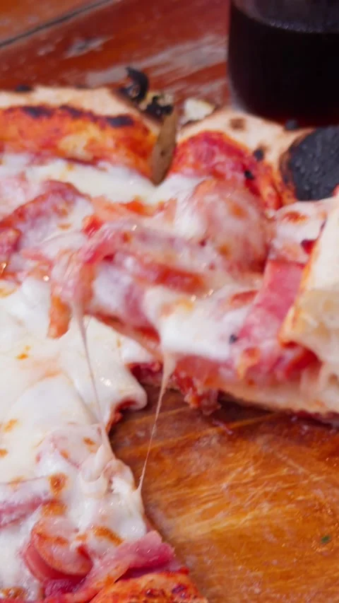 Hand Pulling Cheese Slice from Wood Fired Artisan Pizza Close-Up Stock Footage 340494585