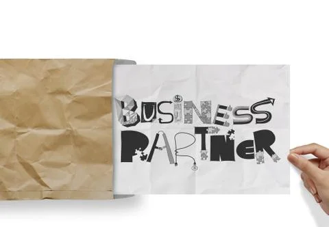 Hand pulling crumpled paper from envelope with design word business partner a Illustrazione stock