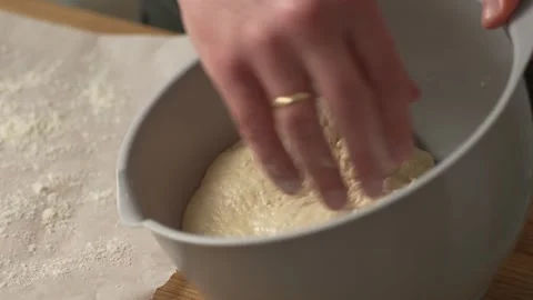 Hand Pulling the Dough out of the bowl. Stock Footage 263363888