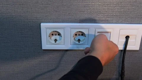 Hand pulling ethernet cable close-up view, unplugging network connector from Stock Footage 333649046