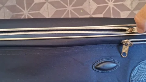 Hand pulling metal zipper on black travel suitcase video footage Stock Footage 339247307
