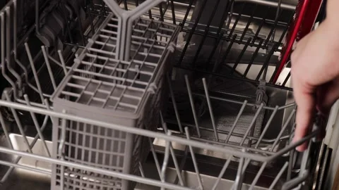 Hand pulling out and repositioning the lower plastic rack in a dishwasher t.. Stock Footage 320738118