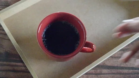 Hand pulling out Red cup of hot coffee in wooden tray Stock Footage 114433890