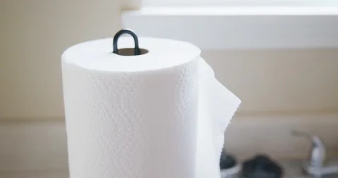 Hand Pulling Paper Towel from Roll Near Sink in Kitchen Stock Footage 125858611