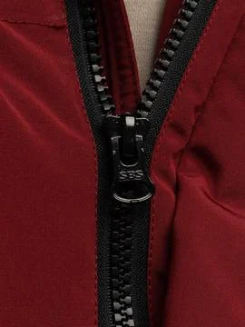 Hand pulling red jacket zipper detail Stock Photos