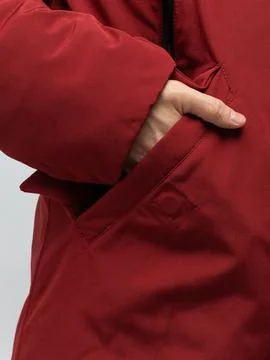 Hand pulling red jacket zipper cord detail Stock Photos