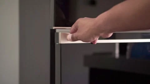 Hand pulling refrigerator door open, kitchen appliance and household concept. Vidéo 342634328