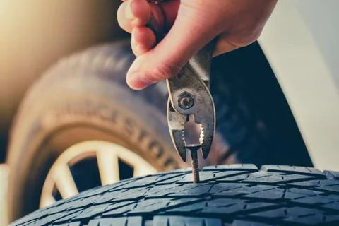 Hand pulling for Removing a Nail in the Tire,Flat tire Fixing and Repair the Stock Photos
