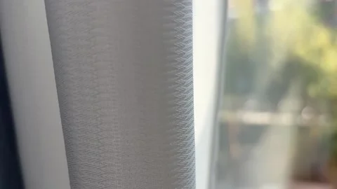 Hand Pulling Semi Sheer White Curtain Closed in Sunlight Stock Footage 332359757