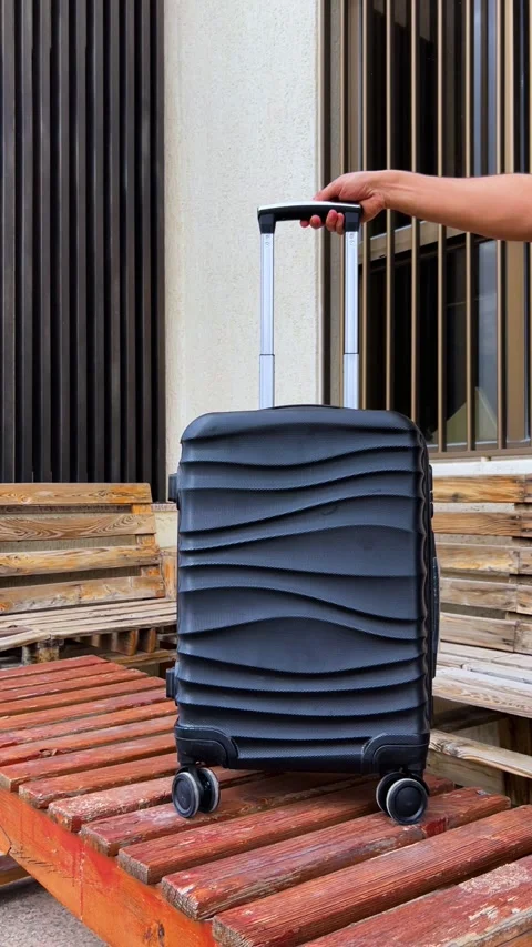 Hand Pulling Stylish Suitcase on Rustic Pallet Stock Footage 303335461