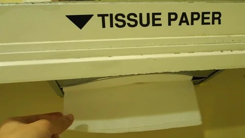 Hand pulling tissue paper sheets out of the box in toilet Stock Footage 85706607