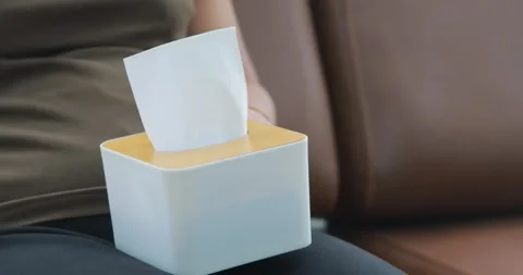 Hand pulling a tissue from a tissue box, tissue box, hygiene and cleanlines.. Stock Footage 341809985