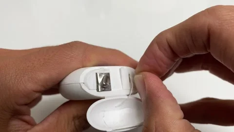 Hand pulling waxed dental floss close up shot on white table background Stock Footage 247964752