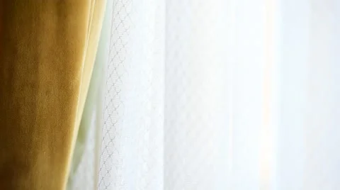 Hand pulling a window curtain for warm daylight to enter the room 스톡 동영상 68147322
