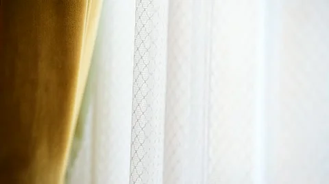 Hand pulling a window curtain for warm daylight to enter the room 스톡 동영상 68147326