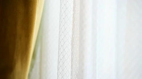 Hand pulling a window curtain for warm daylight to enter the room Stock Footage 68147327