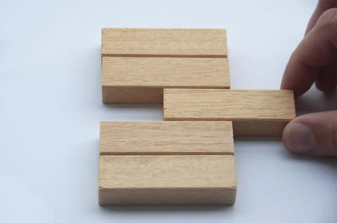 Hand pulling a wooden block with customizable space for text or ideas. Copy s Stock Photos