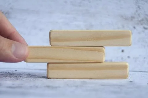 Hand pulling wooden blocks with customizable space for text or ideas. Copy .. Stock Photos