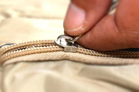 Hand pulling a zip Stock Photos