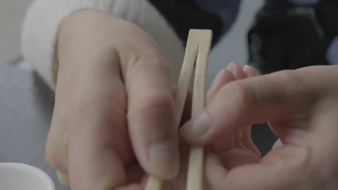 Hand pulls apart chopsticks slow motion Stock Footage 217559626