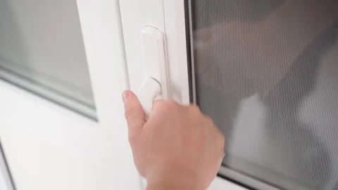 A hand pulls on the handle of the white plastic doors, unsuccessfully. Attempt Stock Footage 204861373