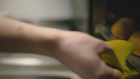 Hand pulls out buns from the oven close-up Stock Footage 73760605