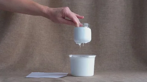 The hand pulls out a jar of white paint. Stock Footage 221941069