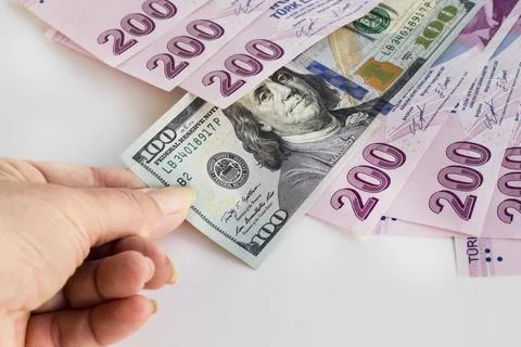 A hand pulls out the US dollar one thousand four hundred Turkish Liras Stock Photos